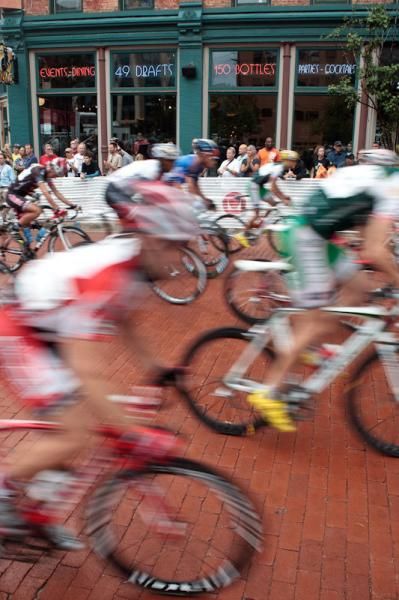 Riders get rolling past fans at the local bar.
