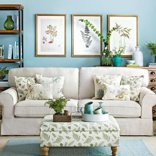 living room with two to three cushions on each side of your sofa and photo frame on wall