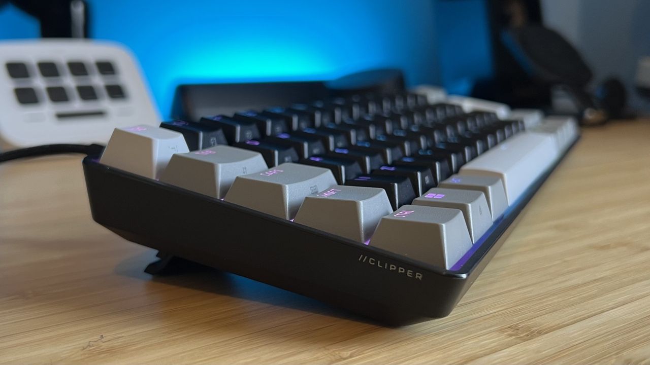 Left side of Corsair Clipper Pro Mini 60 gaming keyboard on a wooden desk