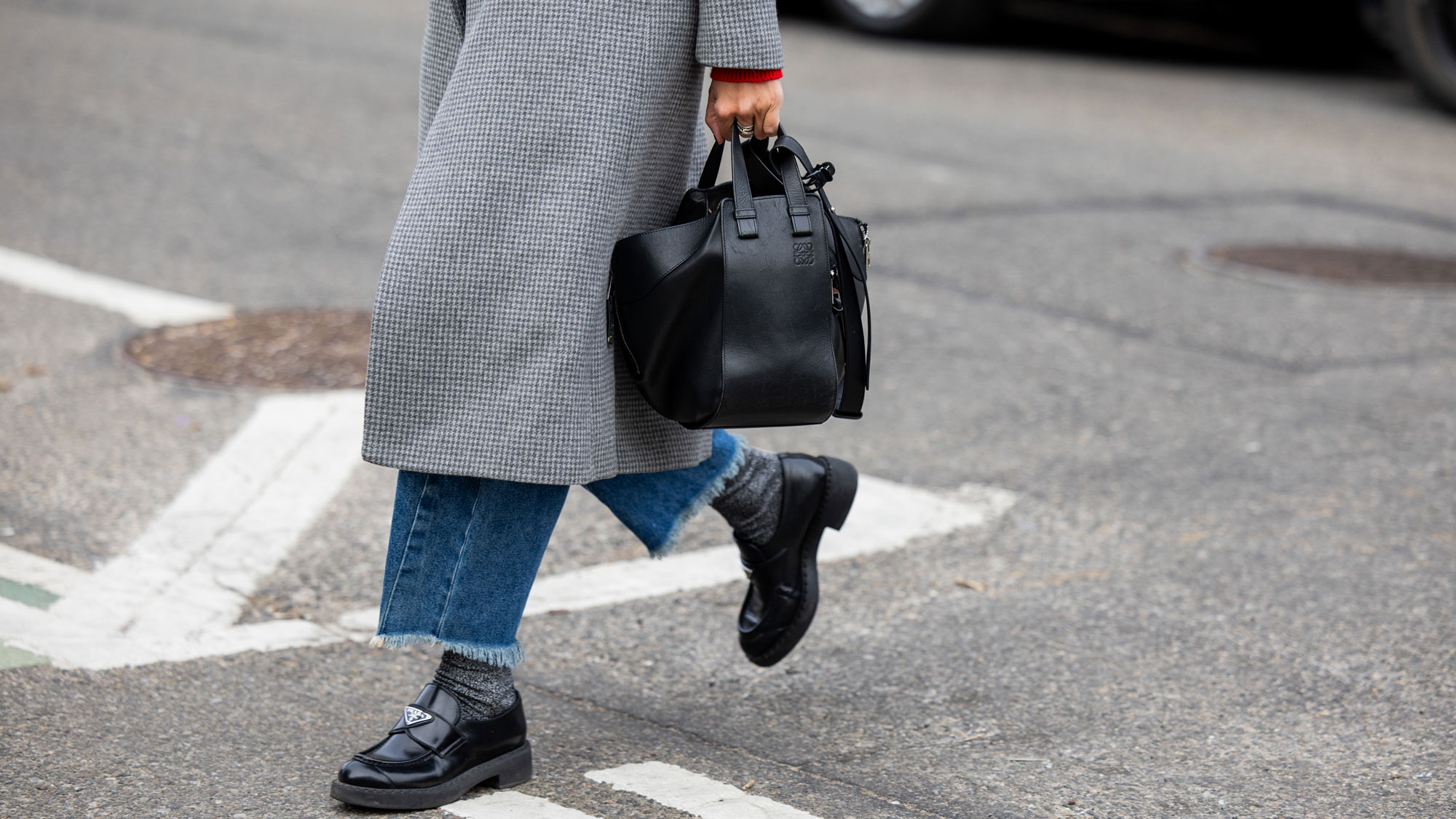 a woman wears Prada loafers