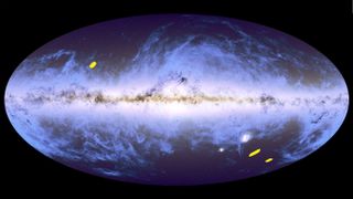 An oval image showing a projection of the night sky with the bright plane of our Milky Way galaxy running horizontally through the center. Cloud-like features representing stars and interstellar gas and dust extend above and below the plane. Three small regions are marked in yellow, indicating the locations of Euclid’s three deep field surveys. One is above and to the left of the horizontal plane, and the other two are to the bottom right. All three are located in seemingly emptier regions, in between the cloud-like features