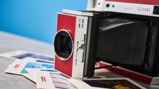 A red and gray Lomography Lomo'Instant Square Glass instant camera