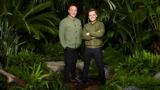 Ant and Dec standing in the jungle wearing green jackets and dark trousers 