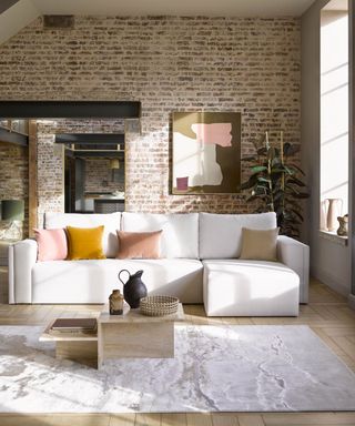 exposed brick wall with large white sofa, cushions and soft rug - sofa.com