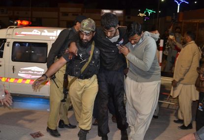 An injured person is rushed to a hospital after an attack in Queeta, Pakistan.