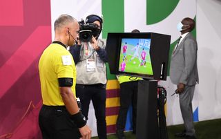 Referee Wilton Sampaio consulting a video replay at the Arab Cup in Qatar
