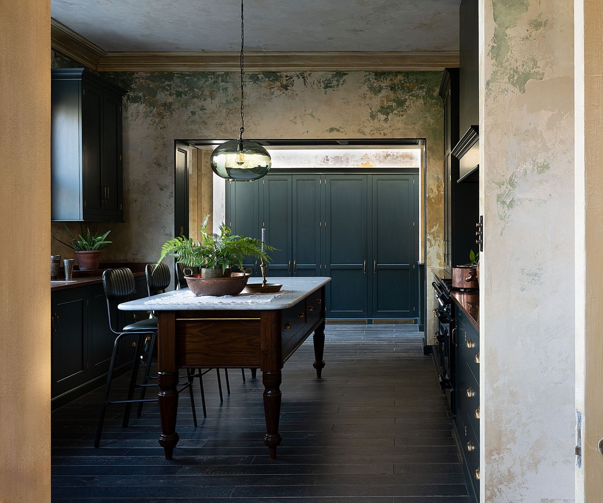 A moody kitchen with a freestanding kitchen island