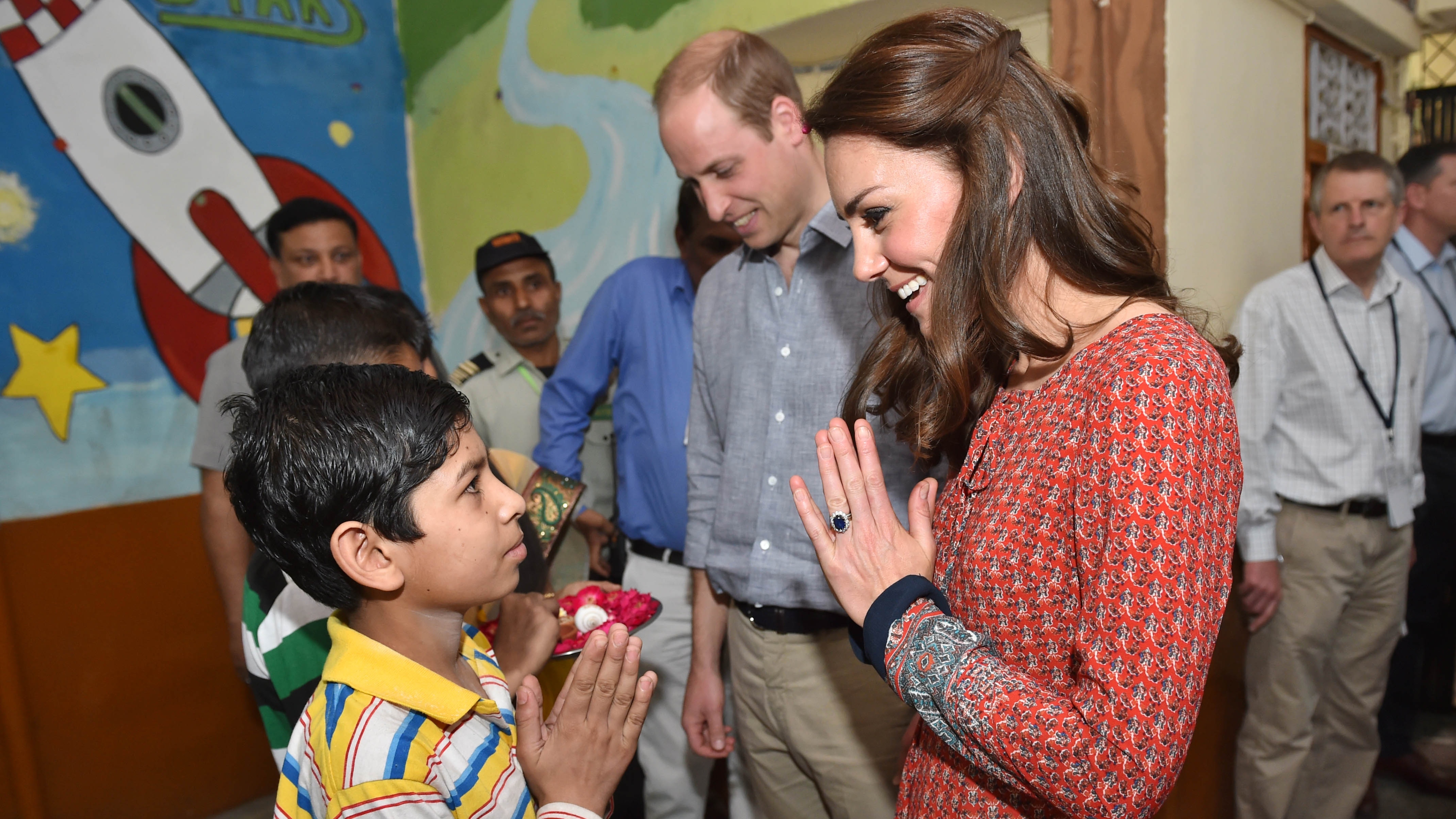 Catherine, Princess of Wales and Prince William talk to children during a visit to a contact centre run by the charity Salaam Baalak