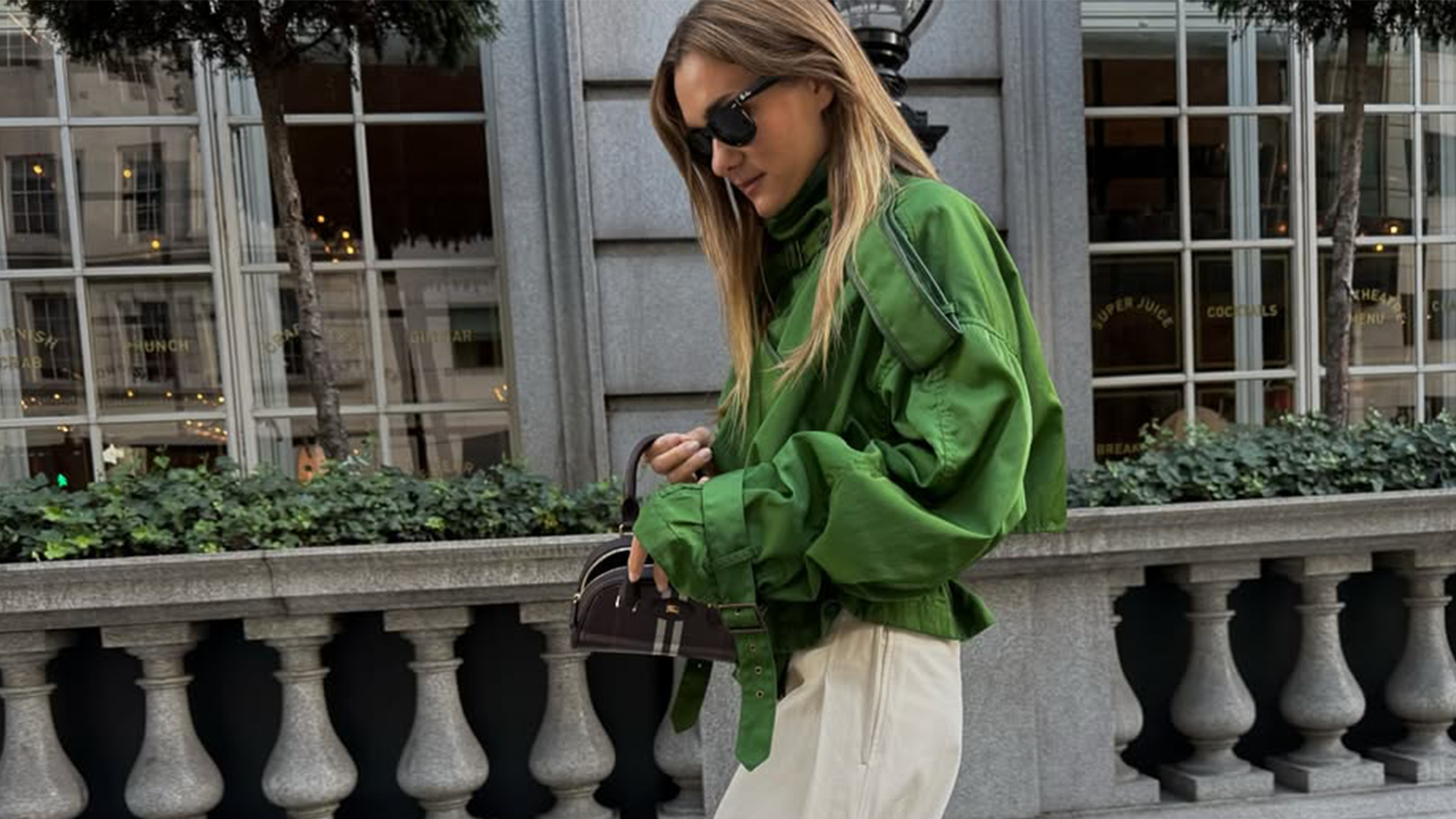 Anne-Laure Mais wearing a green funnel-neck jacket in Paris