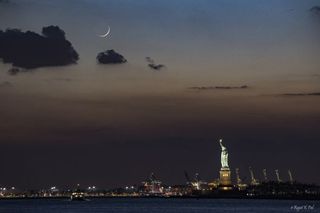 a crescent moon hangs over new york city