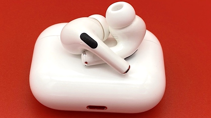 The AirPods Pro wireless earbuds sitting atop of wireless charging case