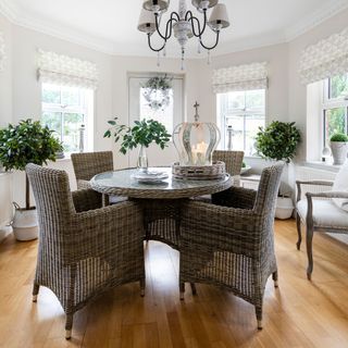 white dining room with table and potted plants