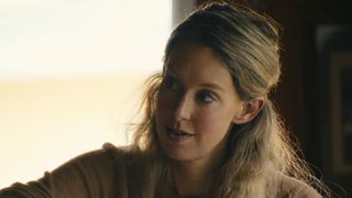 A close up of Elizabeth Holmes looking to her right, wearing a tan sweater in You Can See Everything