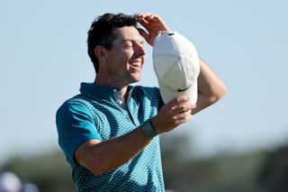 Rory McIlroy smiles whilst wearing WHOOP wristband
