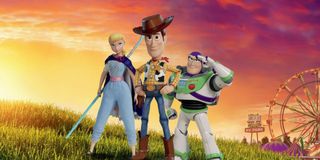 Toy Story 4 Bo Peep Woody and Buzz stand on a hill, as the sun rises on the fair