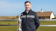 Mark Darbon poses next to The Open Championship trophy at Royal Portrush during the media day in 2025