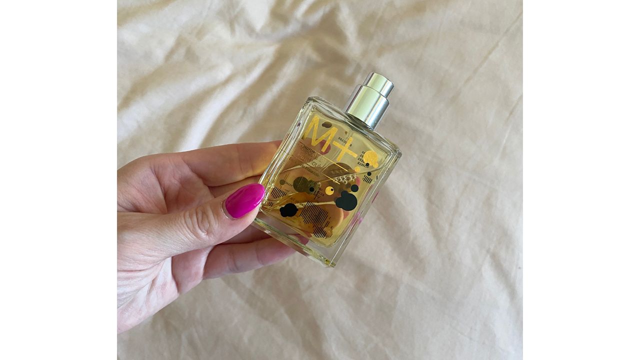Image showing hand holding Escentric Molecules 01 + Patchouli
