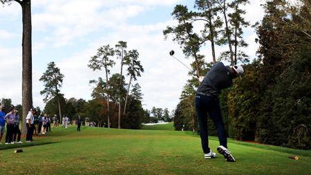 Dustin Johnson hits a drive on the 18th at Augusta National