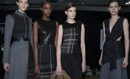 4 female models in dark office-style clothing 