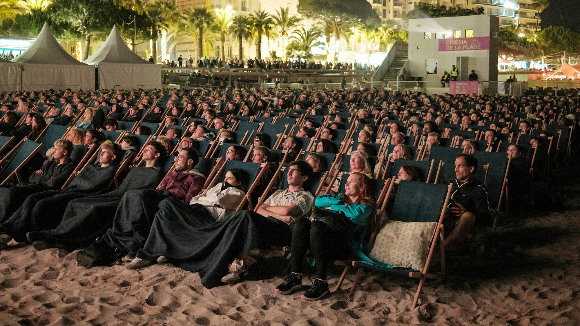 Guests attend a beachfront cinema screening during the 79th Cannes Film Festival in Cannes, France