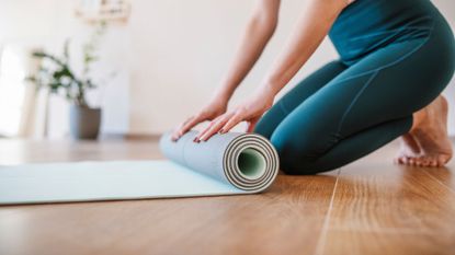 A woman doing a low impact Pilates workout at home