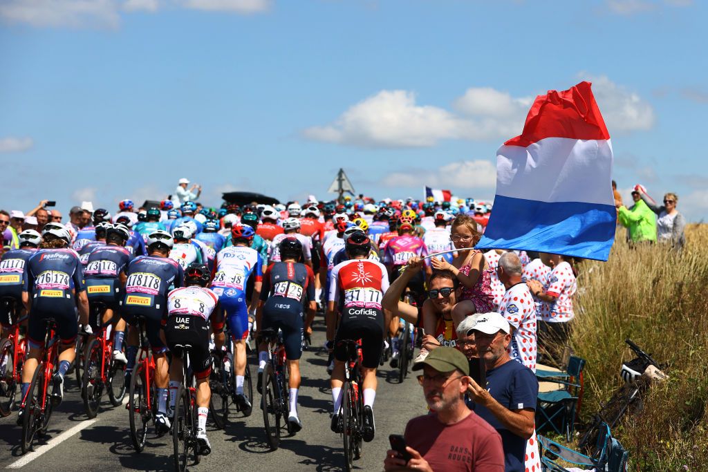 CALAIS FRANCE JULY 05 A general view of the Peloton passing through the Cte de RemillyWirquin while fans cheer during the 109th Tour de France 2022 Stage 4 a 1715km stage from Dunkerque to Calais TDF2022 WorldTour on July 05 2022 in Calais France Photo by Michael SteeleGetty Images