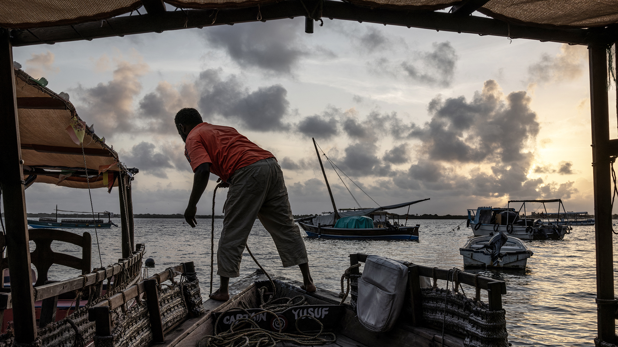 A man prepares his boat near the proposed construction site of one of Africa's biggest oil refineries, on Lamu Island, off the coast of Kenya