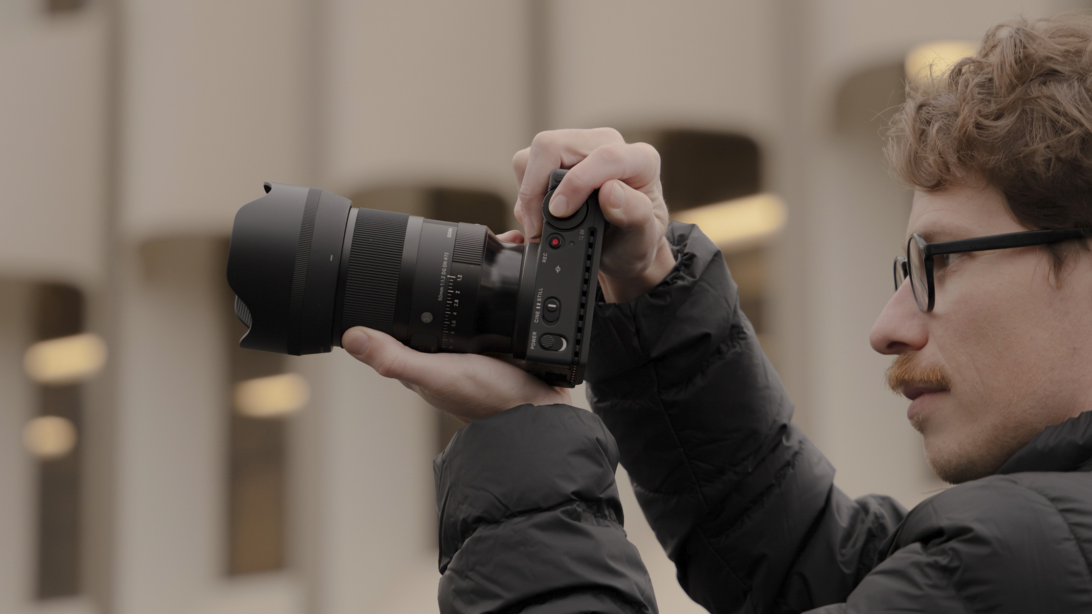 Sigma 50mm F1.2 DG DN Art lens in the hand