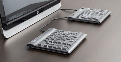 The best ergonomic keyboards buying guide showing the Matias Ergo Pro in use with a HP computer
