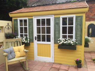 wooden shed yellow coloured and chair
