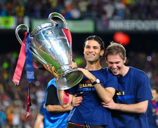 Rafael Marquez (L) holds the UEFA Champions League trophy with Aleksander Hleb at the Nou Camp stadium the day after Barcelona won the UEFA Champions League Cup final on May 28, 2009 in Barcelona, Spain. Barcelona beat Manchester United in the final in Rome.