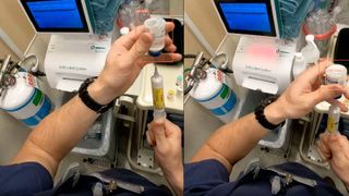 A doctor drawing medication out of a vial with a syringe 