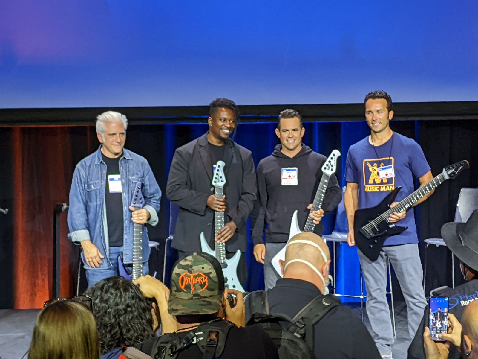 (from left) Rick Beato, Tosin Abasi and Ernie Ball's Brian Ball and Drew Montell onstage at the 2022 NAMM show in Anaheim, California