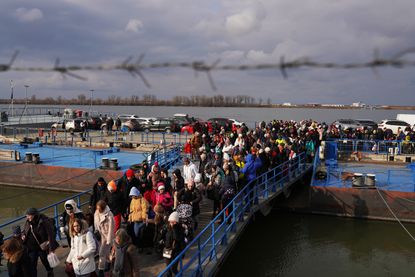 Ukrainian refugees enter Romania after arriving by ferry