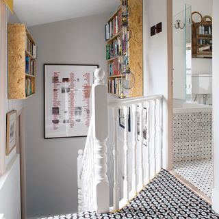 stairway with books shelves and geometric carpet