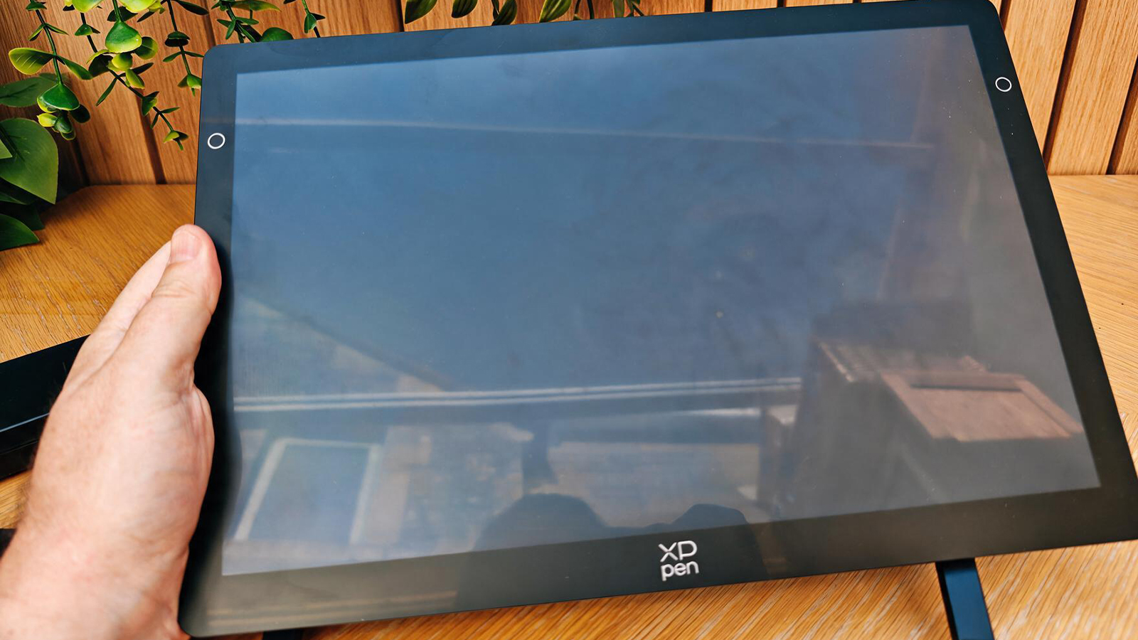A drawing tablet on a wooden desk