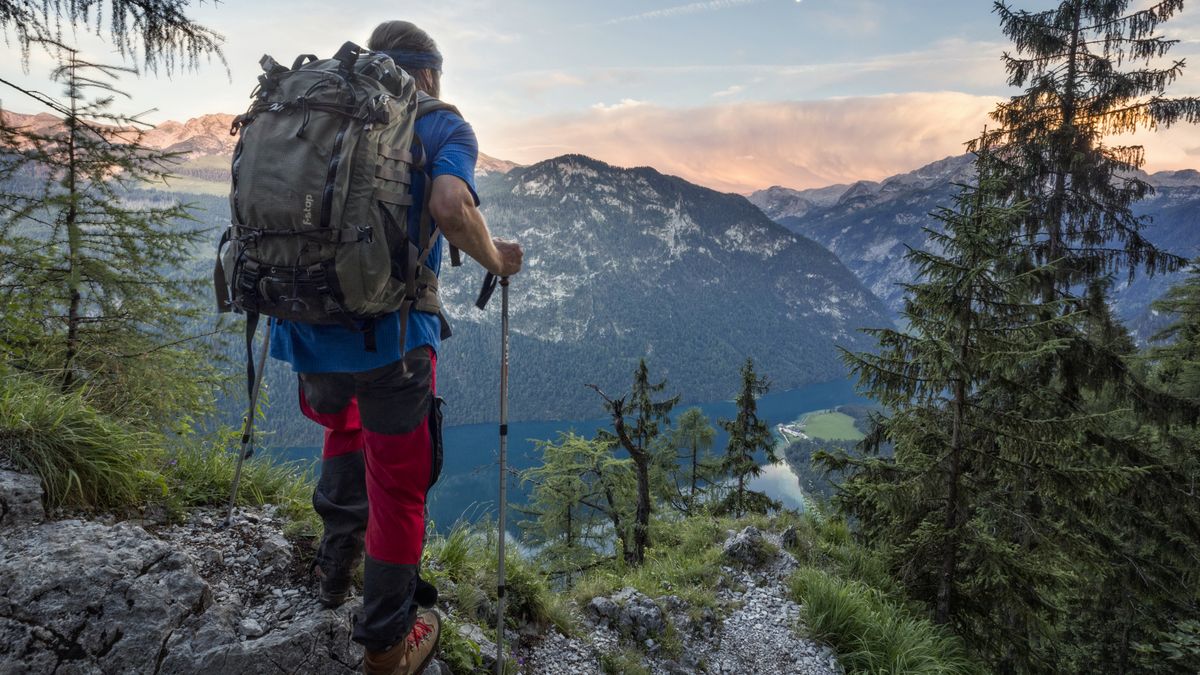 Hiker with view to Lake Königssee and St Bartholoma church