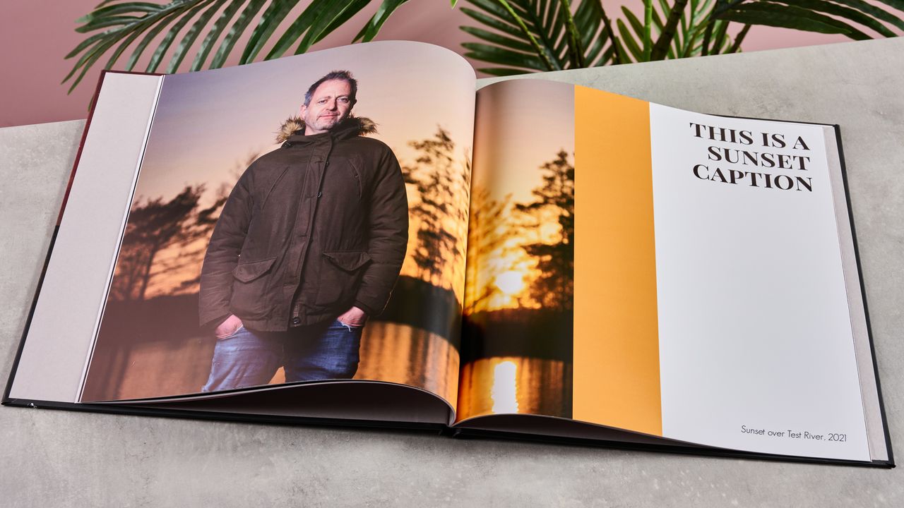 The interior of Blurb photo book showing a man standing in front of a sunset, with a vertical amber bar alongside it and a caption reading 'This is a sunset caption'.