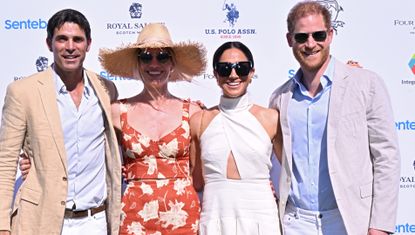 Meghan Markle wearing a white dress at a charity event
