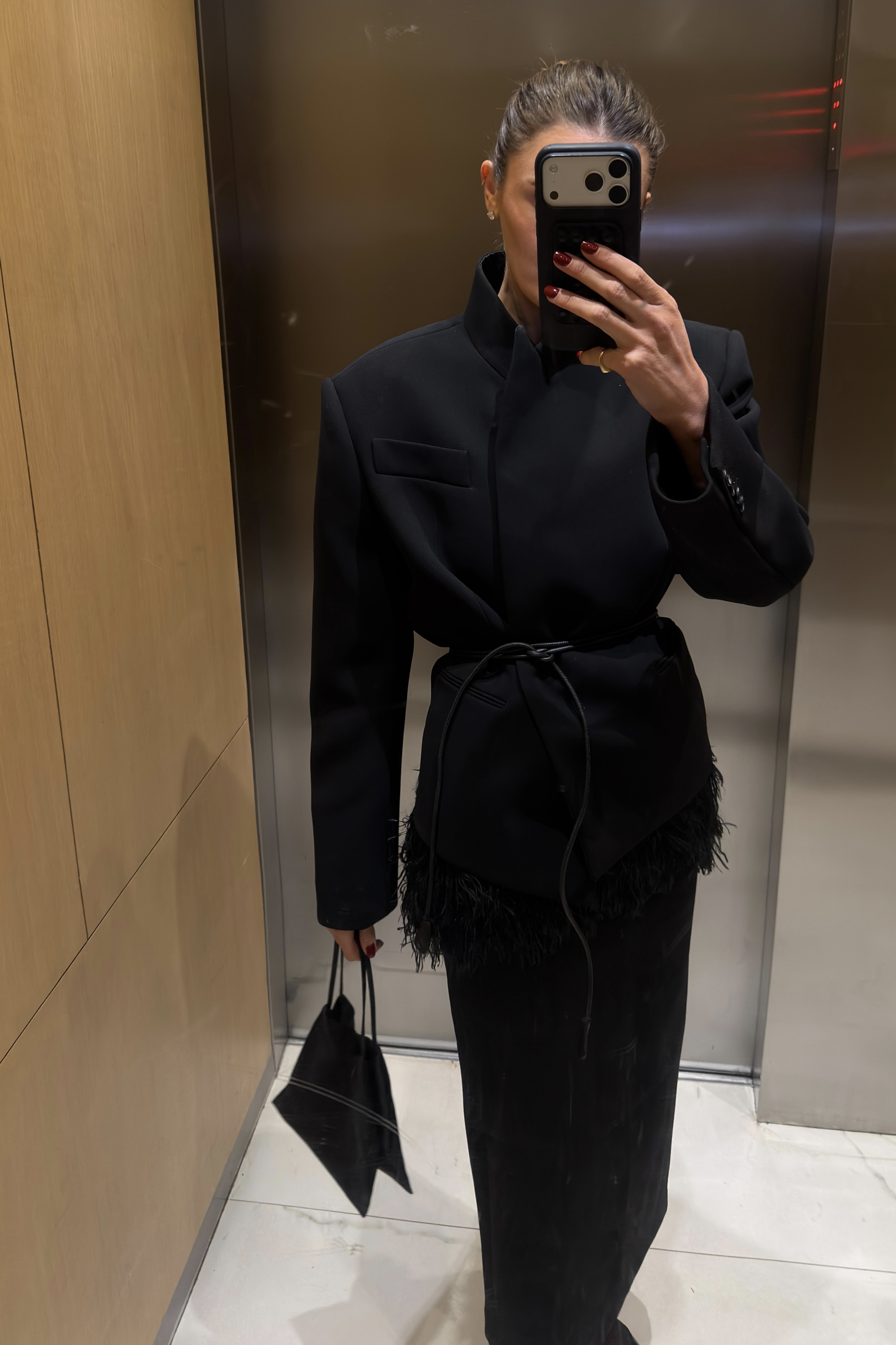 Coco Schiffer in a black fringe blazer