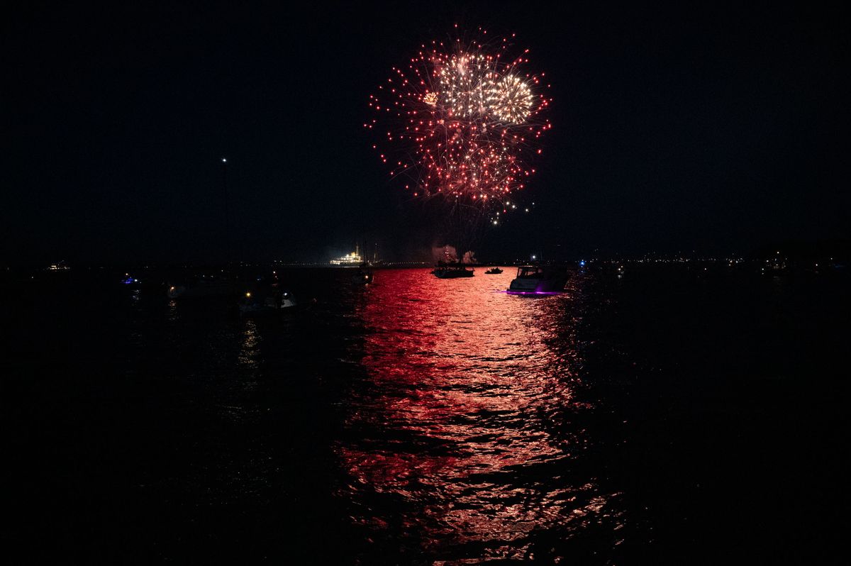 Fireworks over the ocean, reflected in the water