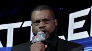 The announcer for BattleBots Pro League speaking into his microphone