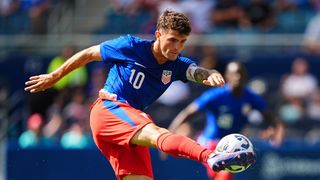 Christian Pulisic #10 of the United States strikes the ball ahead of the