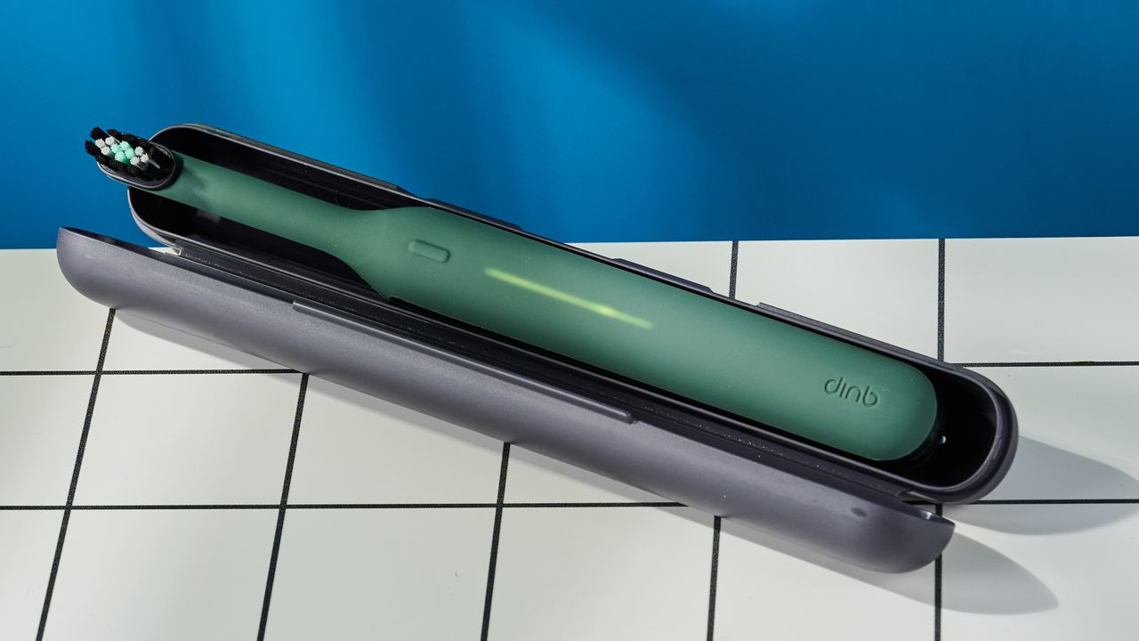 Quip Ultra Next Generation Smart Sonic Electric Toothbrush photographed in front of a blue background.