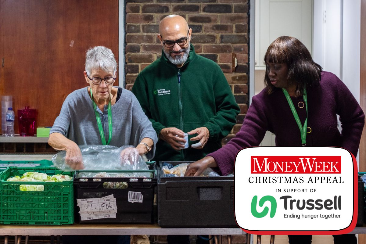 Volunteer Sara and Southwark Foodbank's Shahid and Genevieve organise fresh food in crates