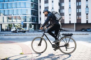 Male cyclist riding in some of the best bicycle commuter pants