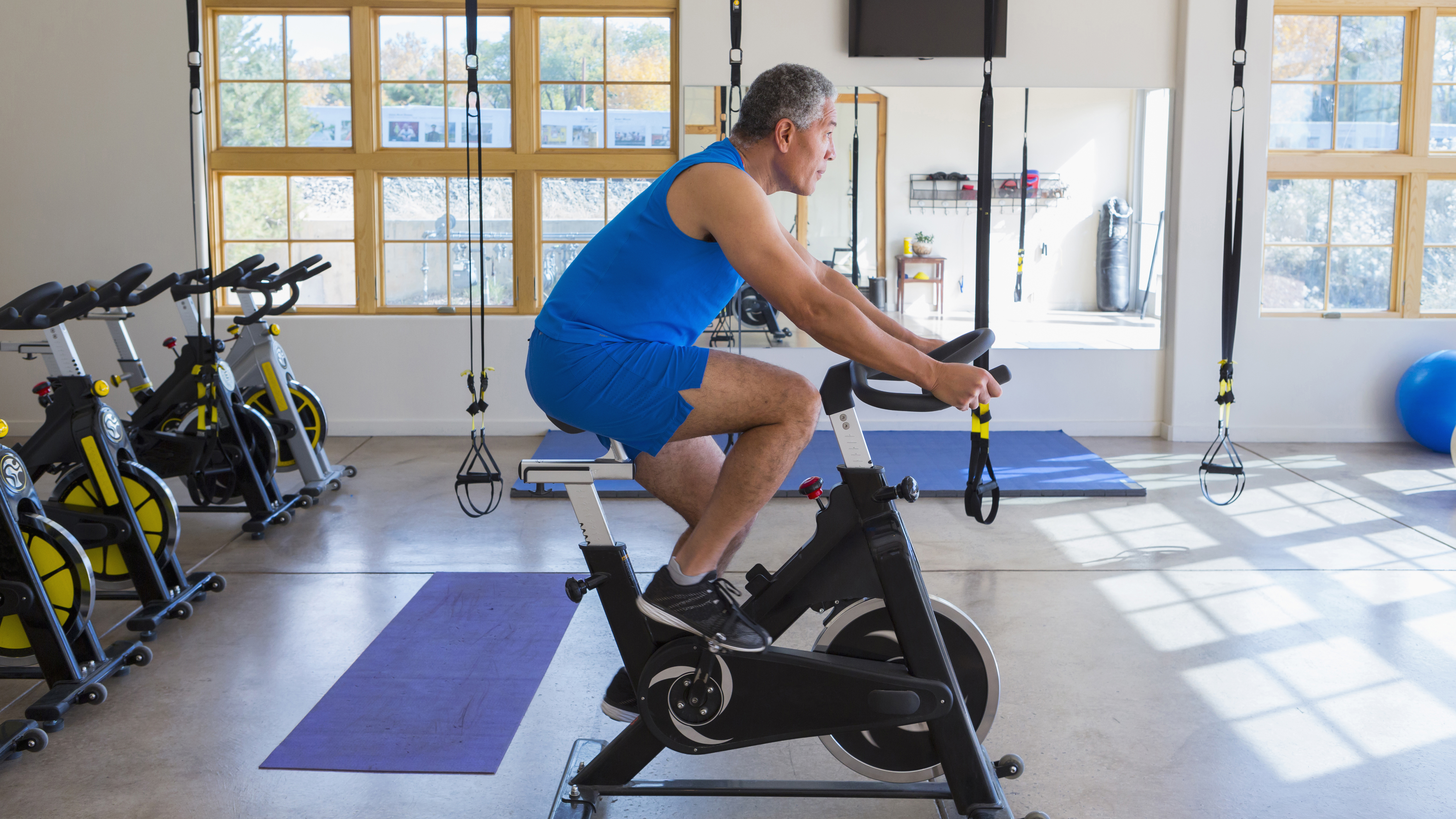 Man works out on stationary bike in gym