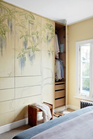Built in closet in yellow with painted mural