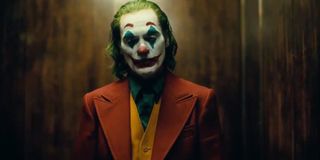 Joker standing in the elevator in full makeup