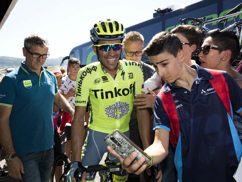 Alberto Contador poses for photos with fans